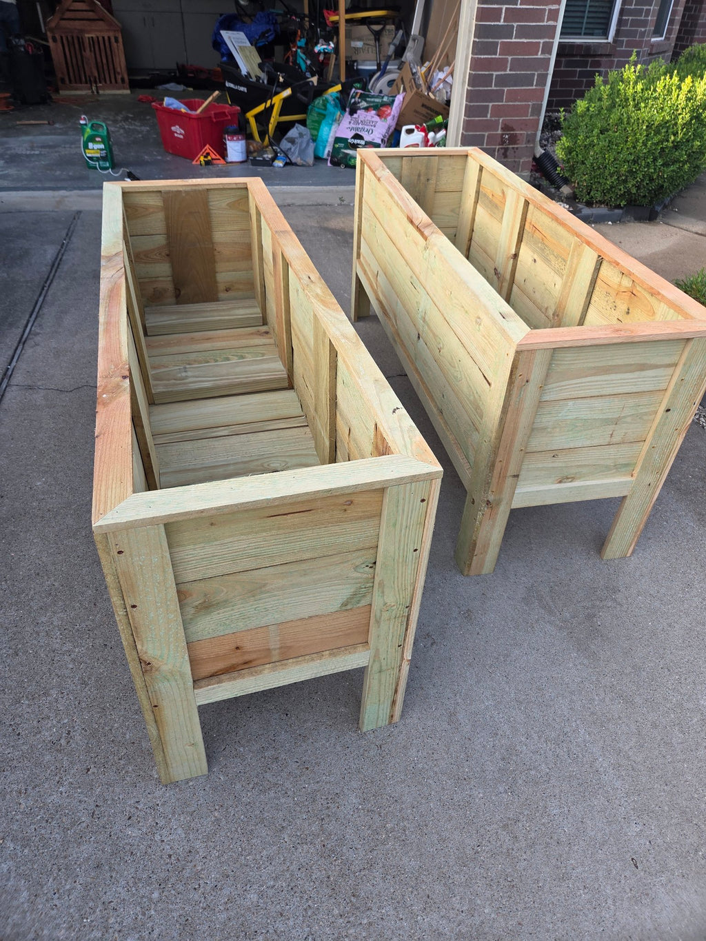 Pair of unfinished wooden raised planter boxes fresh from the workshop